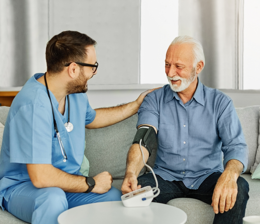 Home visit healthcare service with doctor supporting elderly patient